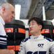 A photo of Yuki Tsunoda and Franz Tost talking in the F1 garage.